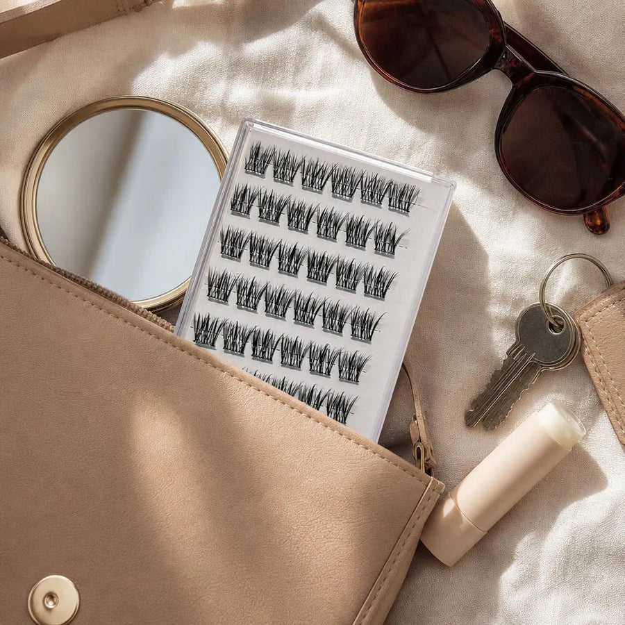 Slim case of lash clusters in an open handbag